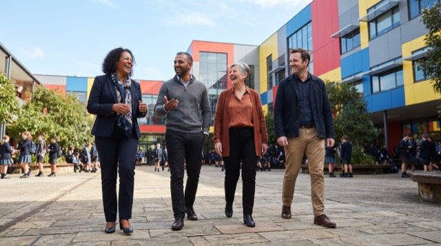 Mood reference: school leaders walking and talking together, relaxed.
